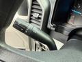 Close-up of a control stalk in a 2017 Ford F-450 Super Duty showing wiper settings and headlight controls with a portion of the dashboard and gauge visible