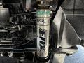 A close-up of a FOX shock absorber mounted on a vehicle with visible branding and a metallic finish