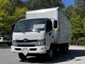A 2020 Hino 155 truck with a white exterior and a box cargo area in front view
