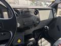Interior view of a 2015 Ford F-750 featuring a dashboard with radio controls and gear shift in the foreground