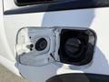 Close-up of the fuel filler cap of a 2015 Toyota Tacoma with the cap removed revealing the fuel inlet