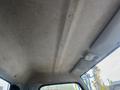Interior ceiling of a 2008 Mitsubishi Fuso FE180 showing a smooth surface with light gray fabric and integrated lights