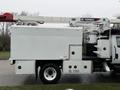 A 2020 International MV607 utility truck equipped with a Terex aerial lift and a large service body with multiple compartments on the side