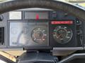 Dashboard of a 1994 Volvo FE 42 showing gauges for speed, RPM, and warning lights with a seatbelt reminder sign