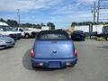 A blue 2007 Chrysler PT Cruiser with a convertible top parked facing away from the viewer featuring a Chrysler logo on the rear
