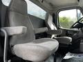 Two gray fabric seats inside a 2012 Freightliner M2 106 truck cabin with a simple design and armrests