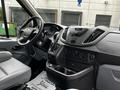 Interior of a 2017 Ford Transit 350 showing the dashboard steering wheel and control panel with various knobs and a gear shift
