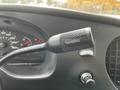A black overdrive control lever with a switch labeled OVERDRIVE OFF in a vehicle interior