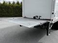 A 2020 Hino 338 truck with an open hydraulic lift gate lowered to the ground for loading or unloading cargo