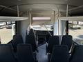 Interior of a 2020 Chevrolet Express showing driver and passenger seating area with multiple seats arranged in rows behind them