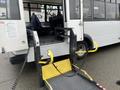 A 2018 Chevrolet Express with a wheelchair lift in the open position ready for use