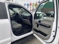 A 2019 Ford F-150 with an open driver's side door revealing the interior featuring a dashboard and seats in a light color scheme