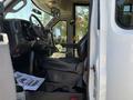 Interior view of a 2017 Chevrolet Express van showing the driver's seat dashboard and side mirror