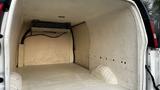 Interior of a 2005 Chevrolet Express van showing an empty cargo area with a ceiling-mounted air conditioning unit