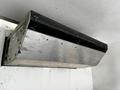 A metallic overhead compartment with a hinged lid inside a vehicle, likely part of an air conditioning or refrigeration system