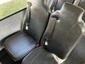 Two black leather seats are shown with seatbelts attached in the interior of a 2022 Blue Bird Vision bus