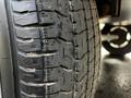 Close-up of a tire from a 2021 Grand Design Recreational 311BHS showing tread depth and texture