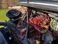 The image shows the engine compartment of a 2016 Freightliner M2 106 featuring various mechanical components and colorful hoses with a red engine block and coolant reservoir visible