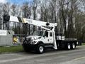 A white 2008 International 7500 truck with a crane attachment labeled National Crane parked on a road
