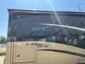 A 2008 Newmar Canyon Star 36 Foot Class A Motorhome with a sleek black and gold exterior showcasing the brand name Canyon Star on the side