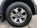 Close-up of a 2014 Ford F-150 wheel featuring a Goodyear tire with winter tread and a silver alloy rim