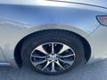 Close-up of the front wheel and tire of a 2017 Acura TLX showcasing a black alloy rim and Michelin tire