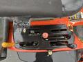 Close-up of the control panel of a 2012 Kubota F3680 featuring levers buttons and gauges for operation