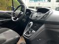 Interior of a 2014 Ford Transit Connect showing the driver's seat steering wheel and dashboard controls