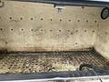 A 2015 Ford F-550 truck with an empty, dirty bed showing stains and dirt on its surface