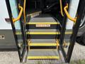 Yellow-highlighted steps leading into a 2020 Chevrolet Express with a warning sign that says Watch Your Step