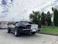 A 1972 Chevrolet Corvette in black with a sleek design, featuring a prominent rear with round taillights and a distinctive silver rear bumper