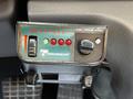 Control panel labeled "Sentinel" with a dial and four LED lights in a Freightliner M2 truck cabin