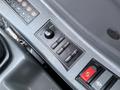 Close-up of a control panel for a 2022 Hyundai R55-9A featuring various buttons and switches for operation and settings