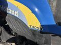 Close-up of a blue and yellow tractor showing the New Holland logo and the model number T4050