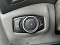 A control dial for headlight settings on a 2016 Ford Transit Connect with several adjustment options including a small circular knob and various symbols