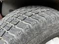 Close-up of a textured tire tread from a 2012 Toro Groundsmaster showcasing deep grooves and wear patterns on the rubber surface