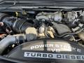 A close-up of a 2008 Ford F-450 SD engine showing the Power Stroke V8 Turbo Diesel components with various pipes and electrical connections