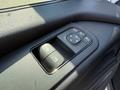 Close-up of a control panel in a 2023 Mercedes-Benz Sprinter featuring buttons for window and side mirror adjustments