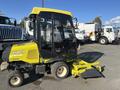 A yellow and black 2010 Kubota F3990 with a cab and a front-mounted attachment designed for turf maintenance