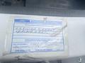 A label on a 2004 Ford Econoline indicating authorized modifications and replacement of the air filter element with dealer number and date