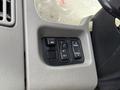 Control panel buttons of a 2010 International 4300 including mirror adjustment and panel light switches