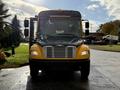 2022 Freightliner B2 bus with a yellow exterior and prominent front grille facing directly towards the viewer