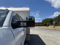 A 2020 Chevrolet Silverado with extended side mirrors parked in a lot