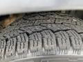 Close-up of a worn tire tread on a 2006 Land Rover LR3 showcasing detailed patterns and grooves for traction
