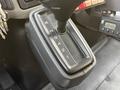 Gear shifter of a 2013 International Durastar 4300 showing positions R N 0 4 2 1 with keys attached on the ignition and dashboard controls visible