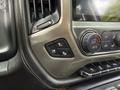 Control panel of a 2017 Chevrolet Silverado 1500 featuring climate control buttons and a digital display for air conditioning settings
