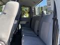 Interior view of a 2016 Ford F-550 showing the back seat with gray upholstery and seat belts