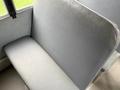 A grey vinyl seat from a 2013 International 3000 school bus with a smooth surface and slightly worn appearance