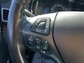 Close-up of the steering wheel control buttons in a 2013 Lincoln MKT featuring navigation and cruise control functions