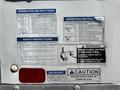 A 2018 Hino 195 utility vehicle with various operational and safety instruction stickers attached to its rear door